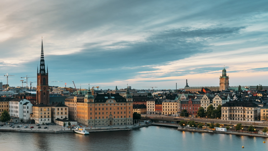 Stockholm, Sweden. Scenic View Of Stockholm Skyline At Summer Evening. Famous Popular Destination Scenic Place In Dusk Lights. Riddarholm Church In Day To Night Transition Time Lapse. Royalty-Free Stock Footage #1060194776