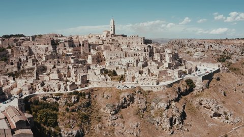 Aerial panoramic view of the ancient town of Matera (Sassi di Matera) in beautiful golden morning light at sunrise, Basilicata, southern Italy. Gorgeous old town from above. Magical Italy.
