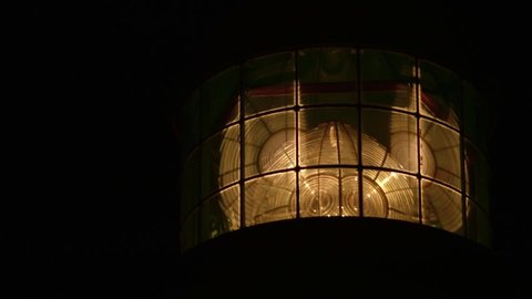 Close-up shot of a lighthouse by night.