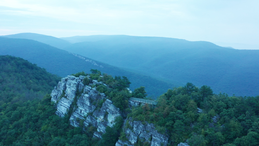 An aerial shot (counter-clockwise orbit) of Big Schloss, Great North Mountain and the Trout Run Valley at dawn in the summer, located on the Virginia/West Virginia Border.