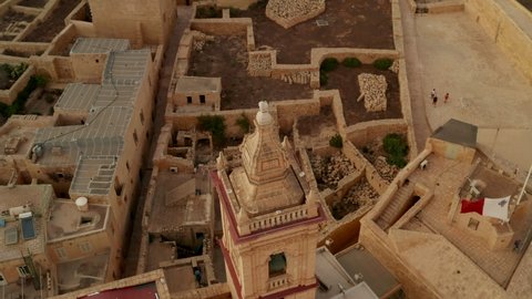Ruins of Gozo Castle Fort on Malta Island with Tower in beautiful Sand Brown Color, Aerial Birds Eye View slide right