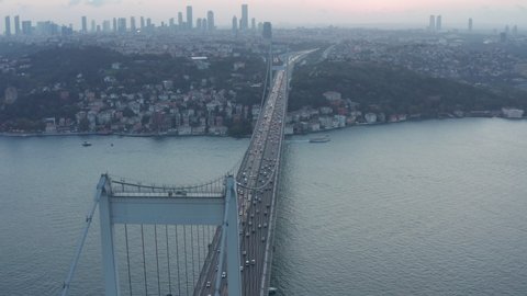 Big Bridge leading into the City Skyline, Car traffic at Sunset in Istanbul, Aerial Dolly Slide left