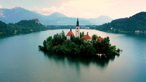 Lake Bled, Slovenia - 4K aerial drone footage of flying around the Pilgrimage Church of the Assumption of Maria (Bled Island) on a sunny summer day