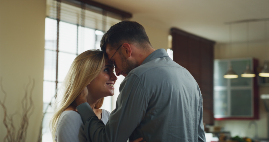 Authentic shot of young handsome man is making a surprise proposal of marriage to his beloved woman in living room at home. The woman is accepting emotionally and giving a hug full of love Royalty-Free Stock Footage #1060217639