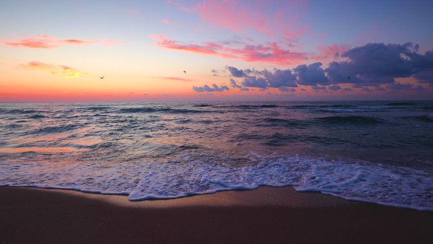 4K Scenic ocean beach sunrise. Sea waves and sand.