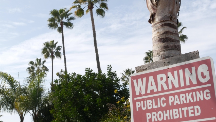 Parking lot sign as symbol of traffic difficulties and transportation issues in busy urban areas of USA. Public paid parking zone in downtown of San Diego, California. Limited space for cars in city.