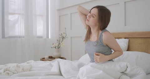 Woman waking up and having pain in shoulder and neck. Woman waking up and having pain in shoulder and neck