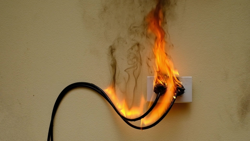 On fire electric wire plug peceptacle on the concrete wall exposed concrete background | Shutterstock HD Video #1060225895