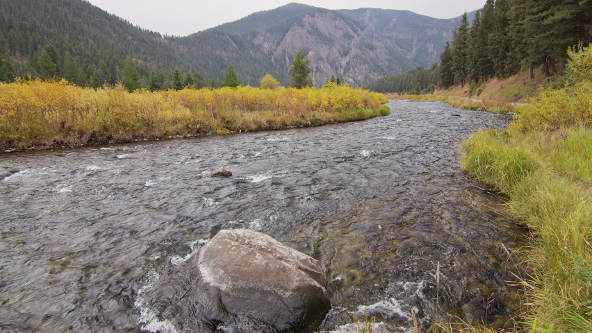 Looking down stream of the Madison River flowing in Fall above Earthquake Lake in Montana.