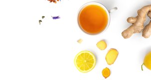Creative animation made of cup of tea, green tea, fruit and herbal tea,turmeric, ginger and lemon on white background.Food concept.