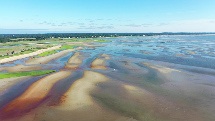 Cape Cod Bay Aerial Drone Footage of Bay Side Beach at Low Tide with Sand Dunes and People Walking in Ocean