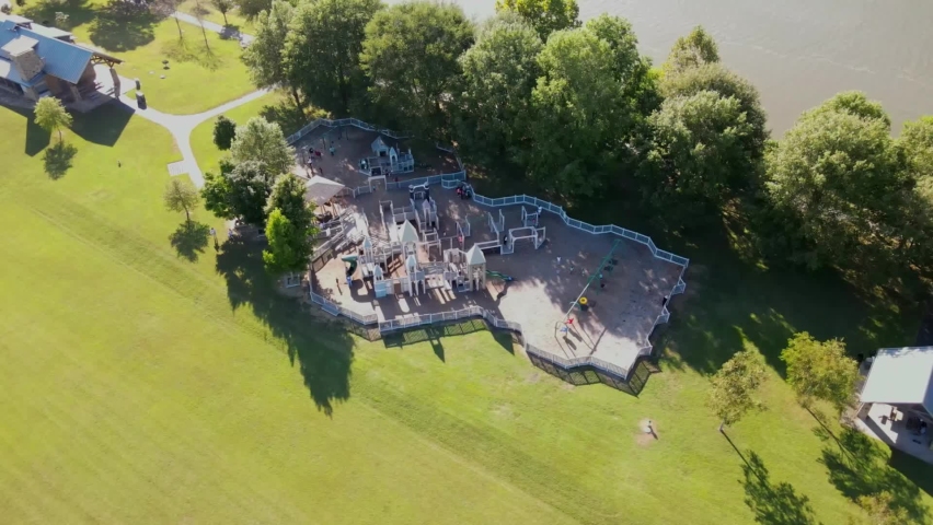 Aerial orbit of a playground sitting beside the Cumberland River in Clarksville Tennessee