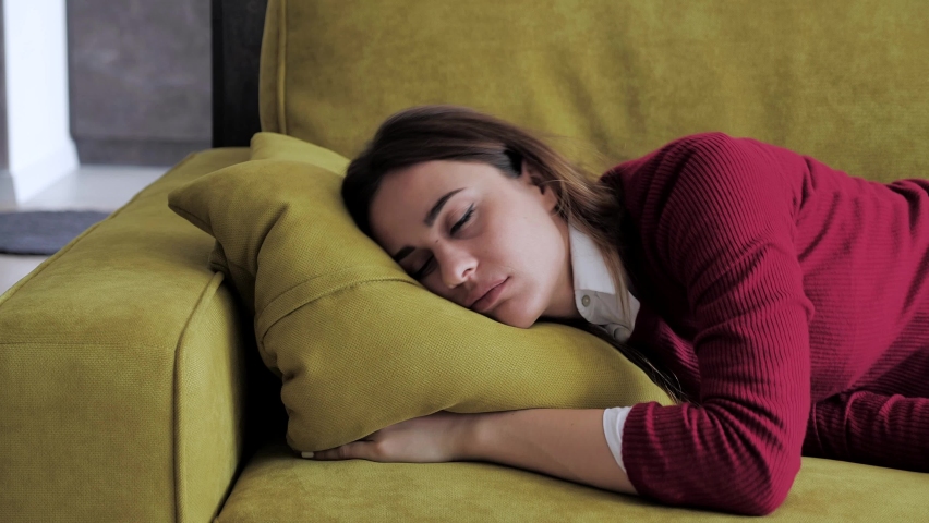 Funny woman lying asleep feeling lack of motivation, fatigue or depression concept. 4k | Shutterstock HD Video #1060231625