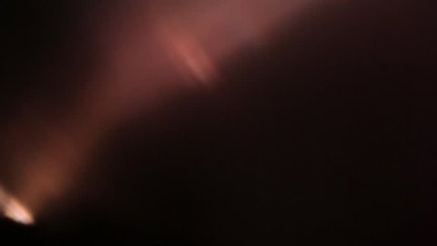 Subtle light leak on black background, moving lens flare. Red - orange - blue pastel colors. Overlay on top of footage for vintage super 8 film effect. 
