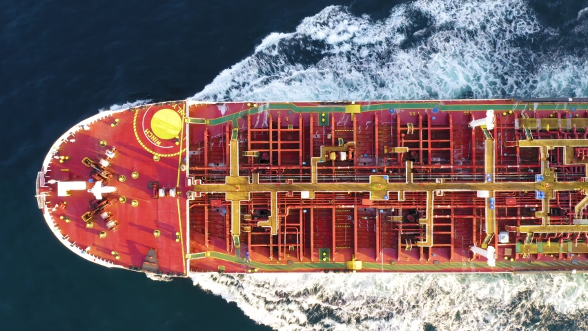 Oil tanker (LPG or chemical) is floating at sea oil port terminal. Oil and gas petrochemical tanker offshore in open sea. Refinery industry cargo ship. Aerial top down view Royalty-Free Stock Footage #1060234091