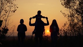 Tourists teamwork. Happy family in the park. Hiker hiking climbing. Happy family of tourists with backpacks going hiking. Silhouette group of tourists in the park at sunset.Teamwork on Hiking. - Powered by Shutterstock - Get 15% off with code: PIKWIZARD15