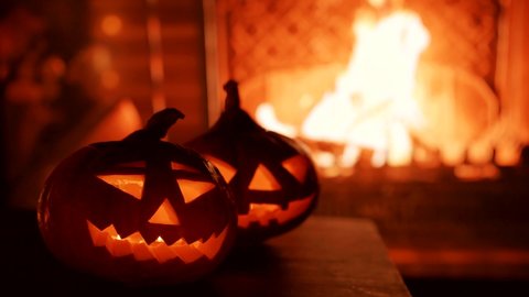 Halloween. Video image of two pumpkins on the background of the fireplace.	
