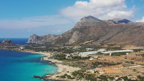 Aerial drone video of Falassarna beach, crystal waters, golden sand, endless sandy turquoise beach of Falassarna in Crete island, Greece. Famous Falasarna (also known as Falassarna or Phalasarna).
