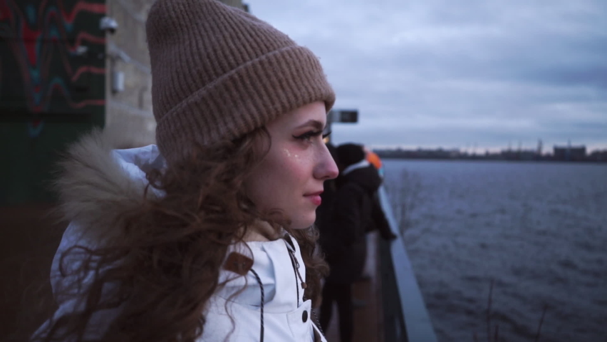 Norwegian Cloudy Sea. The girl is enjoying the view. Scandinavian Foggy seascape. Cloudy dramatic landscape. Blue time