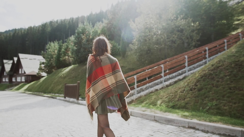 hipster girl in a green hat and cloak walks the streets of Switzerland.Woman In Hat Enjoying Sun