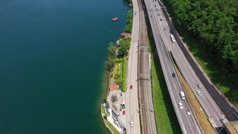 Aerial footage with a tilt up motion of the bridge over lake Lugano between Melide and Bissone in Canton Ticino in Switzerland