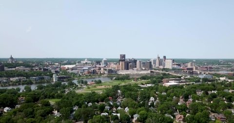Wide aerial view of St. Paul's city skyline with suburban neighborhoods in the foreground.