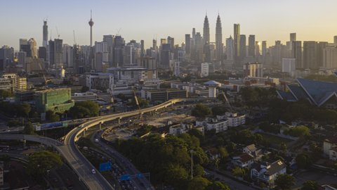 Malaysia Time lapse Sunrise : Aerial city after dawn overlooking Kuala Lumpur city skyline and the Kuala Lumpur General Hospital with busy roundabout and streets. Prores 4KUHD