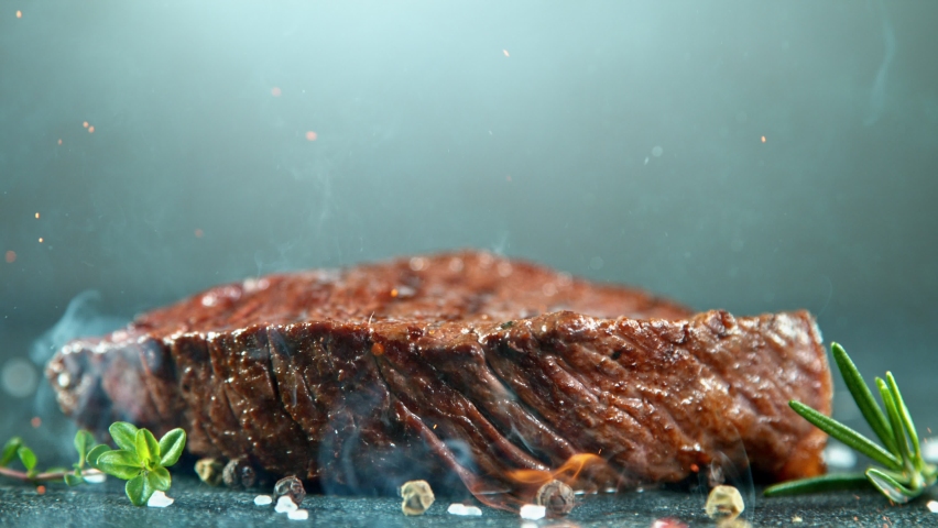 Close-up of falling tasty beef steak, super slow motion, filmed on high speed cinematic camera at 1000 fps. Royalty-Free Stock Footage #1060272701