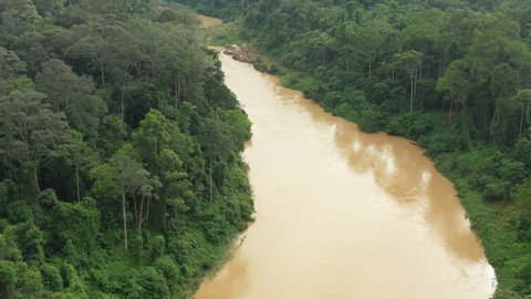 View from above, stunning aerial view of a tropical rainforest with the Sungai Tembeling River flowing through. Taman Negara National Park, located in Malaysia is one of the world's oldest rainforest.