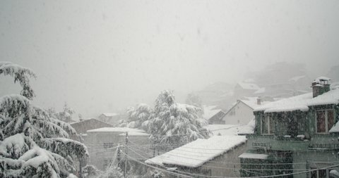 Snow in the city. Heavy snow falling in the city neighbourhood in daytime