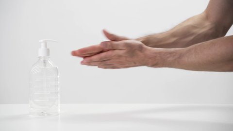 Man putting hand-sanitizing gel  gel on his hands 