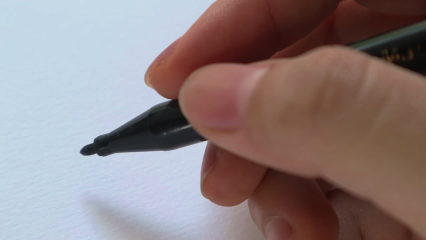 The hand is writing the word job