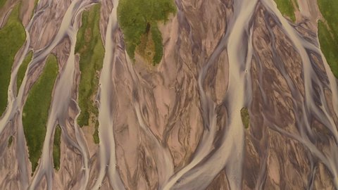 Aerial: Glacial river Meltwater mixed with natural mineral sediment in river deltas creating stunning pattern Iceland Forwards movement  