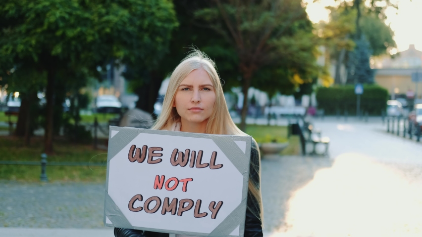 Protest walk: woman holding placard with words that people won