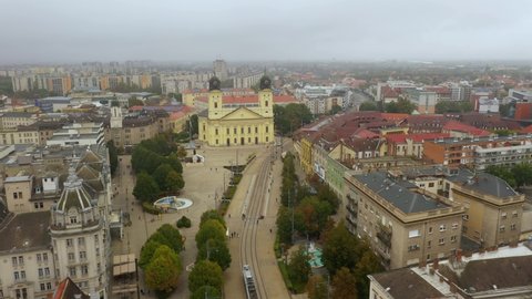 Drone footage from the Church at Debrecen citys main squarein rainy weather autumn
Drone flies fast right