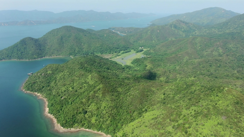 Aerial view of Hong Kong bay with lush green mountain terrains.