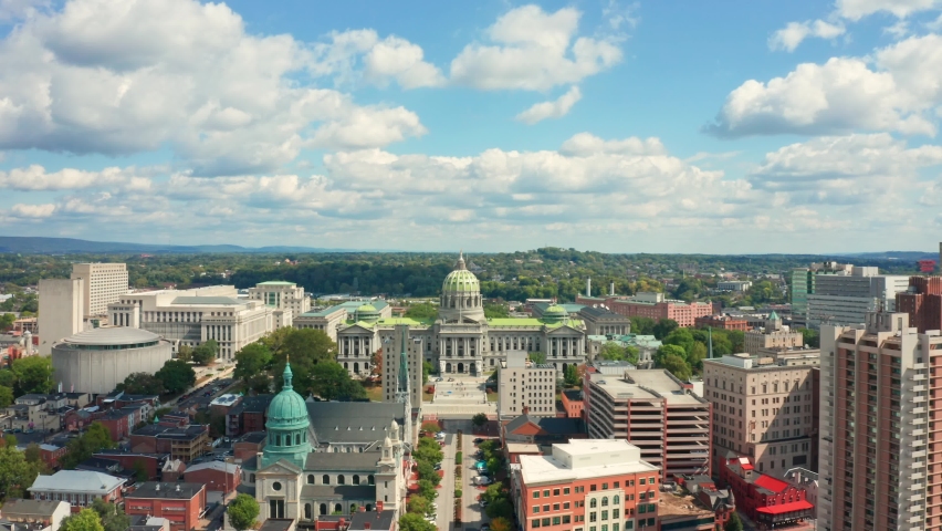 Aerial view of Harrisburg, Pennsylvania state capitol with slow camera approach towards its dome, along State street.