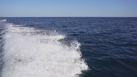 Video of waves, splashes from a motor boat going on the sea. Beautiful sea wave on a Sunny day. slow-motion