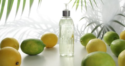 cologne bottle with lemon over white background