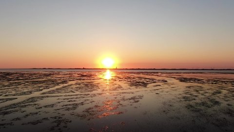 Stunning Orange Sunset Over Tidal Flat Of North Sea In Germany