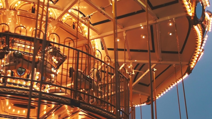 Carousel in amusement park at night Incredible colorful flashing light of vintage merry go round circus horse ride
