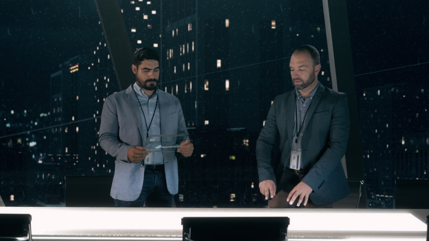Mockup of Electric Vehicle: Automotive engineers working on design of Detailed Electric Car Chassis using futuristic transparent screens and AR Holographic Surface High Tech Table. High-tech facility  Royalty-Free Stock Footage #1060323095