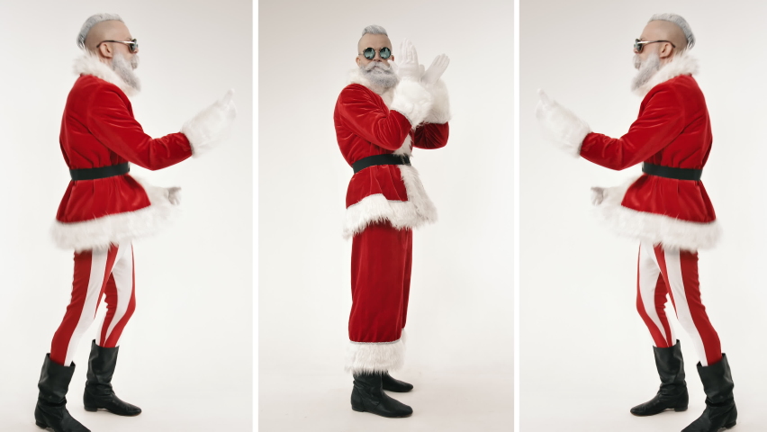 Energetic Active Dance of Emotional Excited Stylish Santa Claus Clapping Hands, Looking at Camera Indoor. Festive Mood on Positive Celebration of Happy New Year, Merry Christmas, Having Fun at Holiday Royalty-Free Stock Footage #1060323908