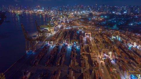 BKK Thailand 24 Jun 19 Aerial view hyperlapse over industrial port of Thailand with many rows and stacks of container in import-export business logistic transportation with Bangkok city in background.