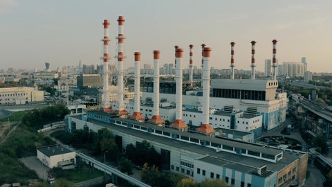 Aerial shot of a modern heat power plant smoke stacks in urban environment