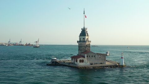 Circling Maiden's Tower with Turkey Flag in the Bosphorus Ocean River in Istanbul in Beautiful afternoon light, Aerial Establishing Shot