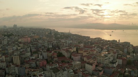 Beautiful Early Morning Above Istanbul Taksim with Galata Tower in Sunrise Light, Aerial Establishing Shot slide left