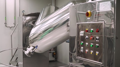 Production of medicines and tablets, view of a special chrome plated mixer tank for mixing powder mixture preparation and medicinal ingredients, the process of rotation, pharmacy and pharmacology.