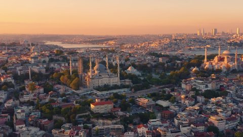 Istanbul, Turkey, Sultanahmet with the Blue Mosque and the Hagia Sophia Grand Mosque (Ayasofya) with a Golden Horn bay on the background at sunset. Aerial view