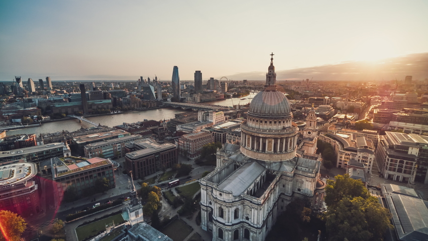 Establishing Aerial View Shot of London UK, iconic St Paul's Cathedral and Riverside, United Kingdom, amazing rays of sun, red flare Royalty-Free Stock Footage #1060344719